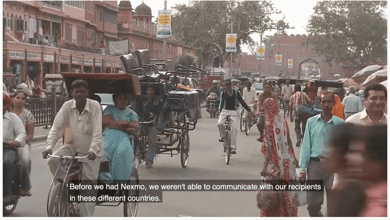 People in India riding bikes and carts on the street