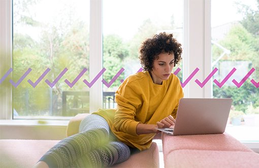 Woman using laptop on couch at home