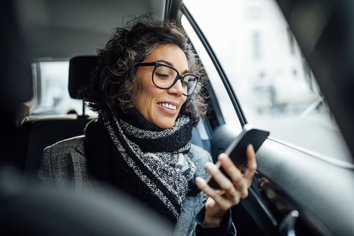 passenger woman in car looking at phone