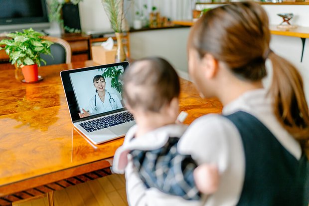 woman and baby doing video chat with doctor