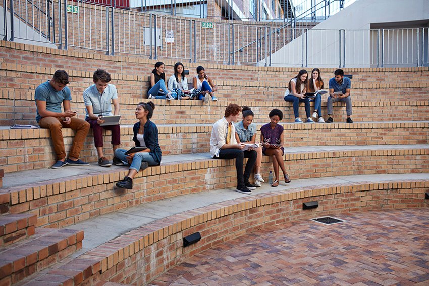 Students studying in groups outdoors on campus