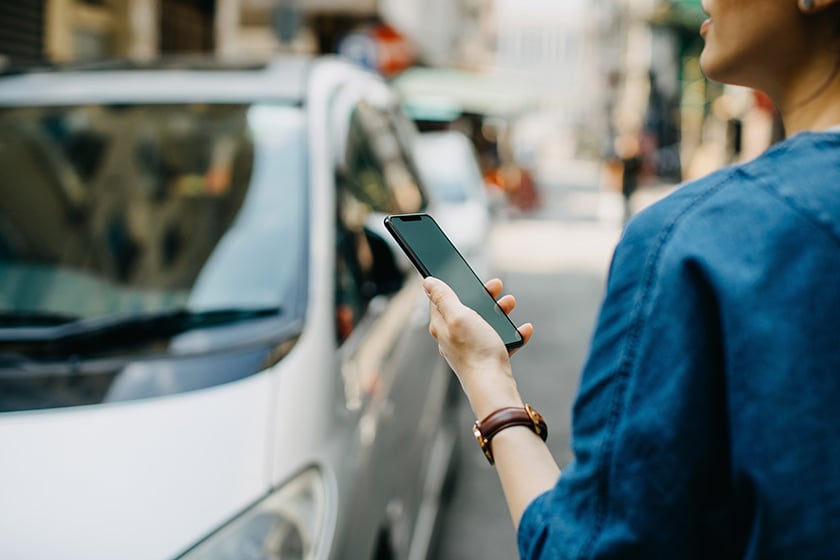 Woman on phone looking at car